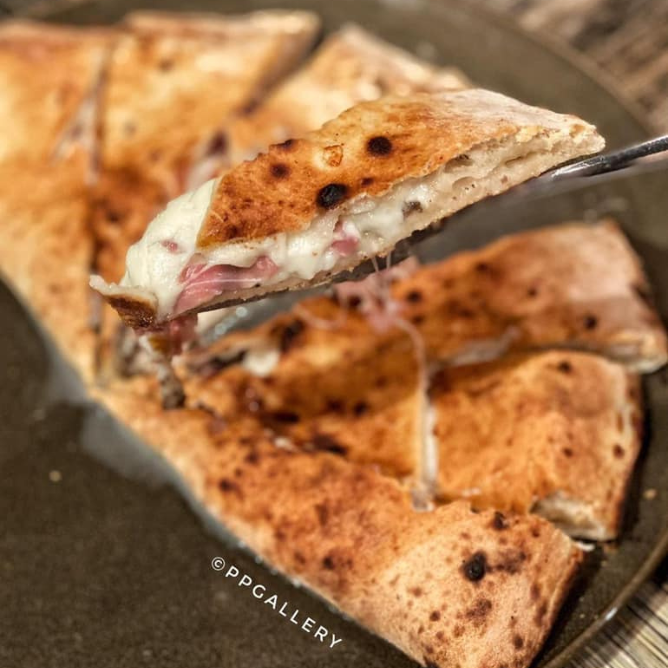 Chef preparing a hand-stretched pizza